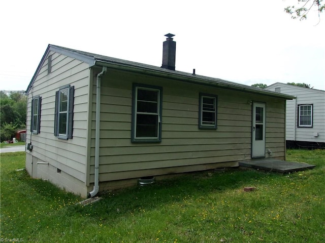 rear view of property with a lawn