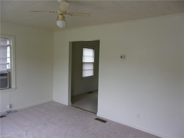 spare room with ceiling fan and light carpet