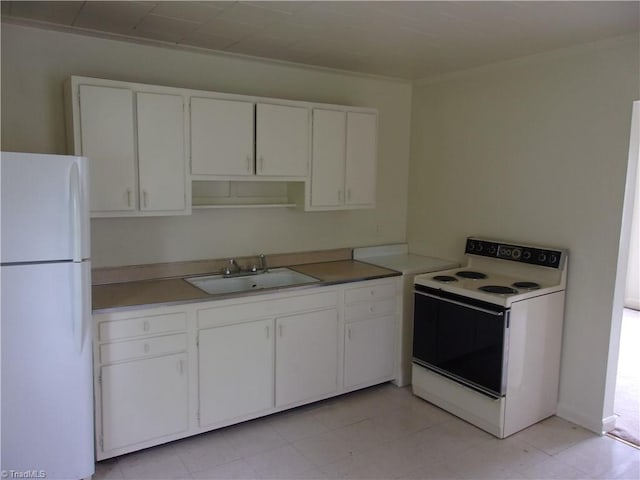 kitchen with sink, white appliances, light tile flooring, and white cabinetry