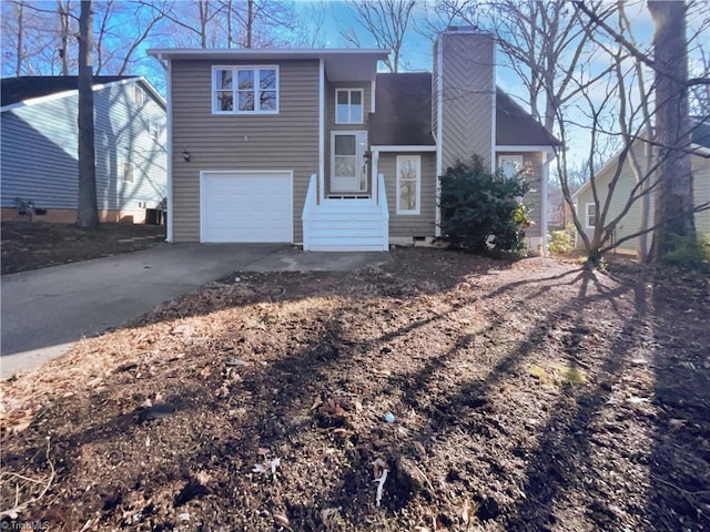 view of front of house featuring entry steps, driveway, a chimney, and an attached garage