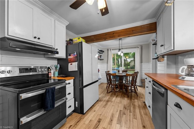 1105 Hawthorne Ln, Burlington, NC 27215 - kitchen with stainless steel appliances, under cabinet range hood, butcher block countertops, crown molding, and light wood-style floors