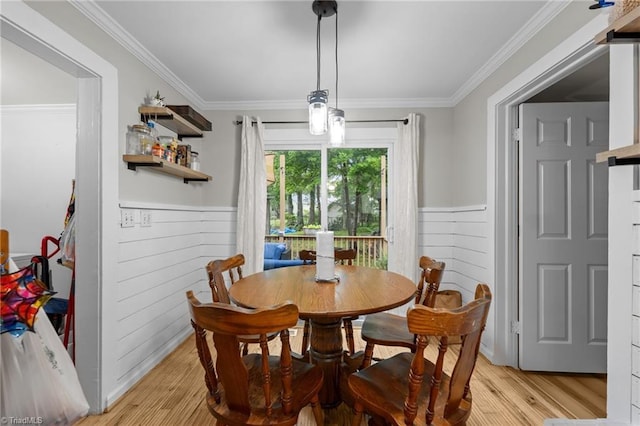 1105 Hawthorne Ln, Burlington, NC 27215 - dining room featuring light wood-style floors, a wainscoted wall, crown molding, and wood walls