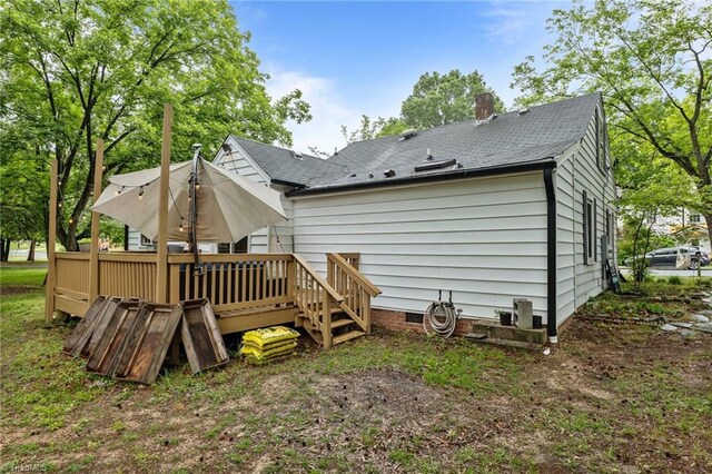 1105 Hawthorne Ln, Burlington, NC 27215 - back of house featuring a wooden deck, a chimney, and a shingled roof