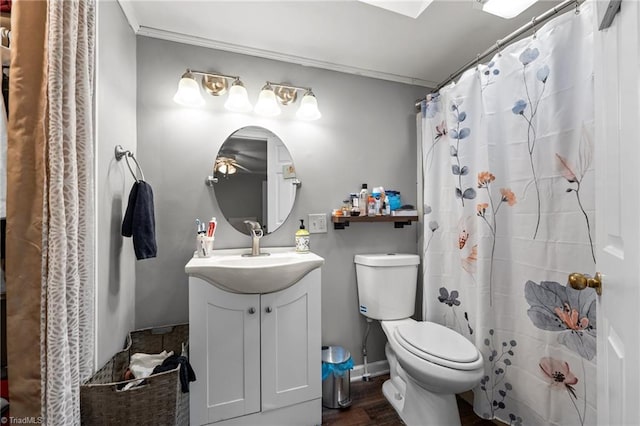 1105 Hawthorne Ln, Burlington, NC 27215 - bathroom featuring toilet, vanity, wood finished floors, and curtained shower