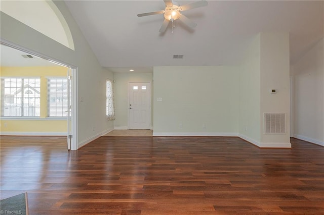 unfurnished living room with a ceiling fan, baseboards, wood finished floors, vaulted ceiling, and visible vents