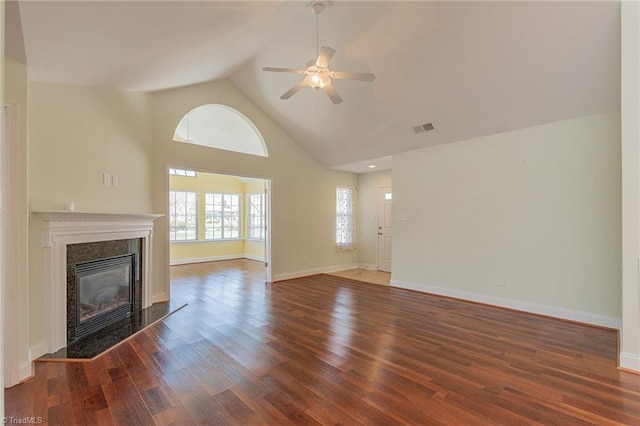 unfurnished living room with ceiling fan, visible vents, a fireplace, wood finished floors, and high vaulted ceiling