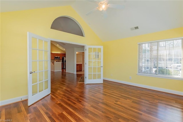 empty room with french doors, visible vents, baseboards, high vaulted ceiling, and dark wood-type flooring