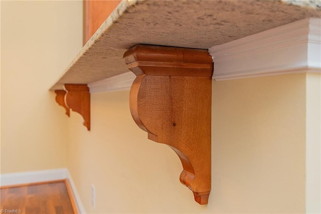 room details featuring baseboards and wood finished floors