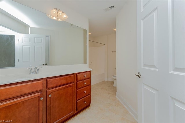 bathroom featuring visible vents, vanity, toilet, baseboards, and tile patterned floors