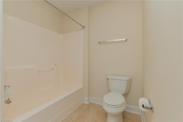 bathroom with toilet, baseboards, bathing tub / shower combination, and tile patterned floors