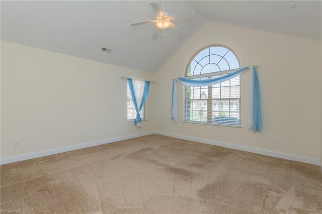 carpeted empty room with baseboards, ceiling fan, visible vents, and a wealth of natural light