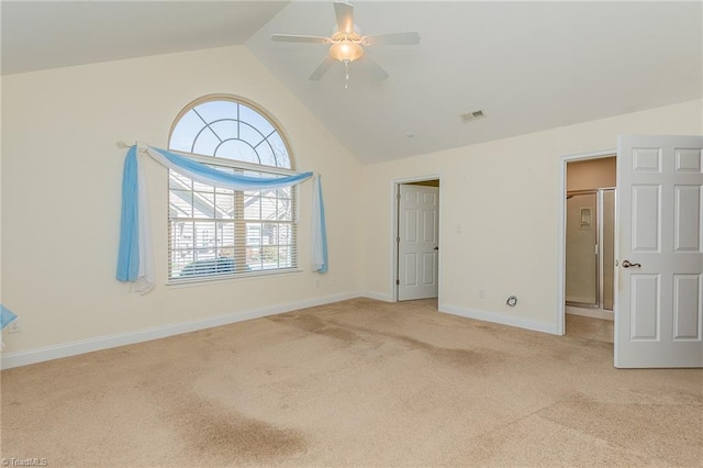 interior space with visible vents, baseboards, ceiling fan, carpet flooring, and vaulted ceiling