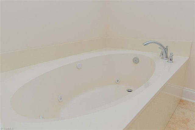 full bathroom with tile patterned flooring and a tub with jets
