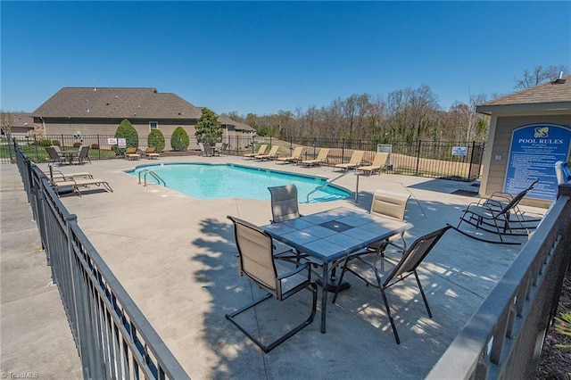 pool featuring a patio area and fence