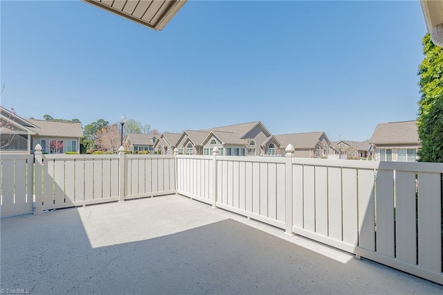 view of patio / terrace featuring a residential view and fence