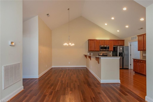 kitchen with visible vents, appliances with stainless steel finishes, brown cabinets, and an inviting chandelier
