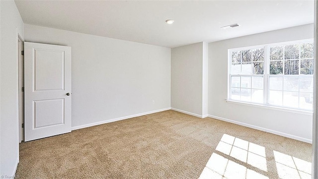 unfurnished room with light colored carpet