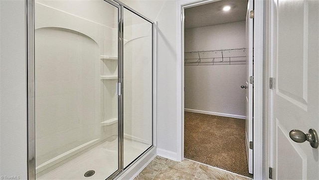 bathroom with a shower with shower door