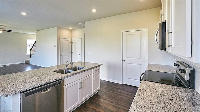 kitchen with stainless steel appliances, sink, ceiling fan, and white cabinets