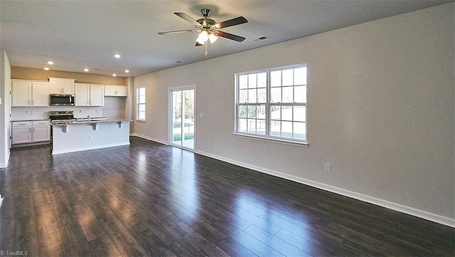 kitchen featuring ceiling fan, stainless steel appliances, white cabinets, and dark hardwood / wood-style floors