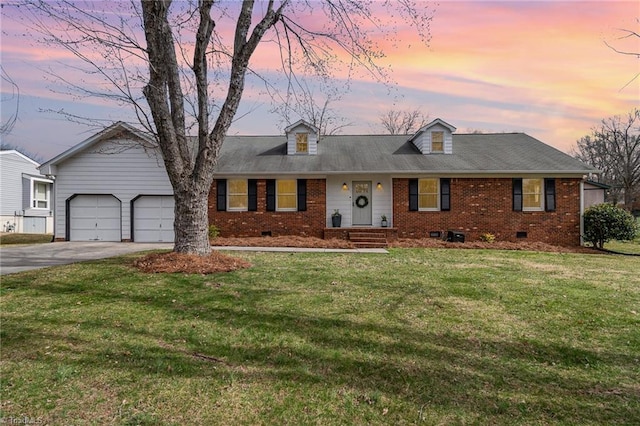 view of front facade with crawl space, brick siding, a yard, and driveway