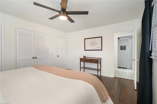 bedroom with dark wood-style floors, connected bathroom, a ceiling fan, and baseboards