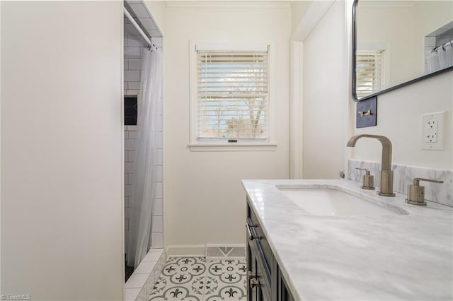 bathroom featuring vanity, baseboards, and tile patterned floors