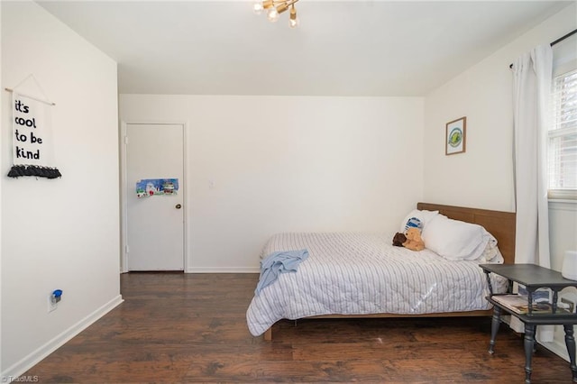 bedroom with baseboards and wood finished floors