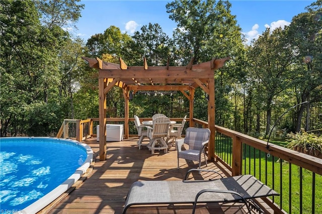 view of swimming pool featuring a deck, a yard, and a pergola