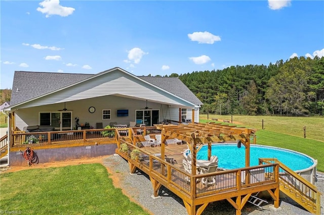 view of swimming pool featuring a deck and a yard