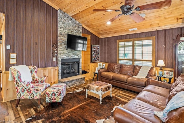 living room with wood walls, wood ceiling, a stone fireplace, vaulted ceiling, and hardwood / wood-style flooring