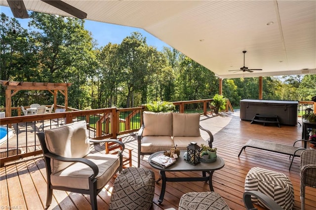 wooden terrace featuring a hot tub, outdoor lounge area, and ceiling fan