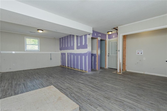 spare room featuring a textured ceiling and wood finished floors