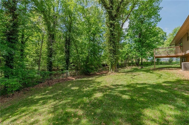 view of yard with a wooden deck and central AC