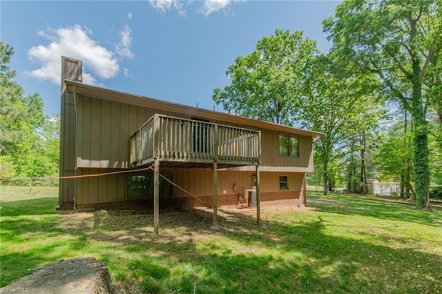 back of property featuring a yard, cooling unit, and a wooden deck
