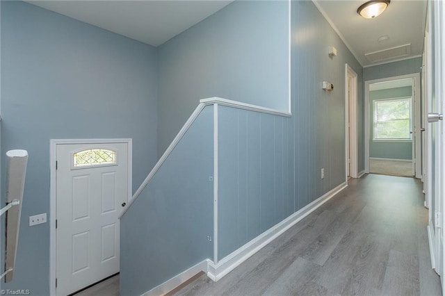 foyer featuring plenty of natural light, wood finished floors, and baseboards