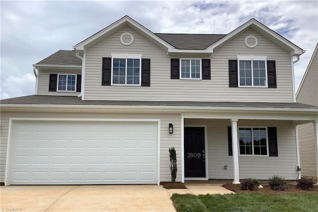 traditional home featuring a garage and driveway