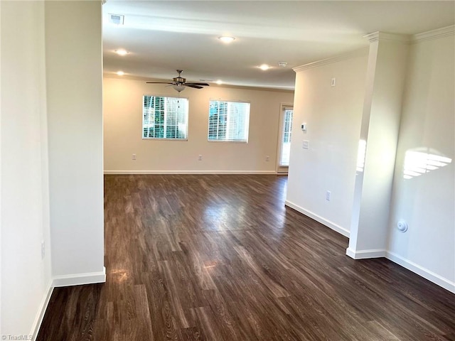 spare room with ceiling fan, dark wood-style floors, baseboards, and ornamental molding