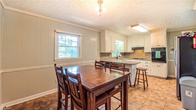368 Shady Grove Rd, Eden, NC 27288 - dining area with a textured ceiling, ornamental molding, and a decorative wall