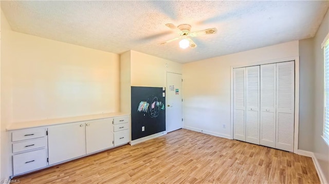 368 Shady Grove Rd, Eden, NC 27288 - unfurnished bedroom featuring light wood-style flooring, a textured ceiling, a closet, a ceiling fan, and multiple windows