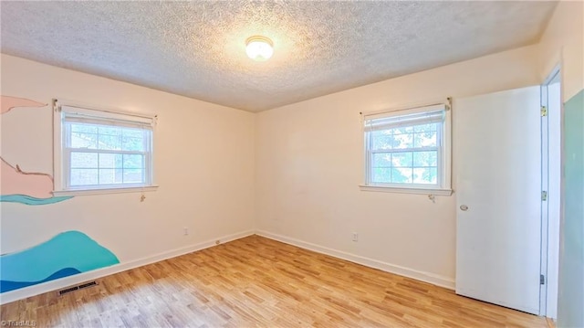 368 Shady Grove Rd, Eden, NC 27288 - unfurnished bedroom featuring a textured ceiling and light wood-type flooring