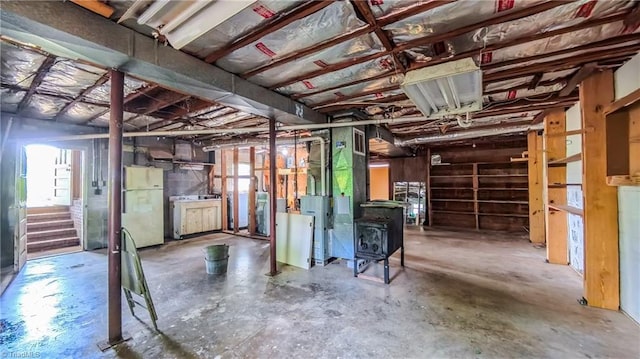 368 Shady Grove Rd, Eden, NC 27288 - below grade area with freestanding refrigerator, a wood stove, and stairway
