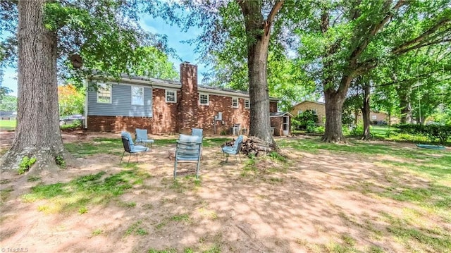 368 Shady Grove Rd, Eden, NC 27288 - back of house with brick siding and a chimney