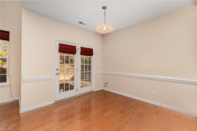 empty room featuring hardwood / wood-style floors and a wealth of natural light