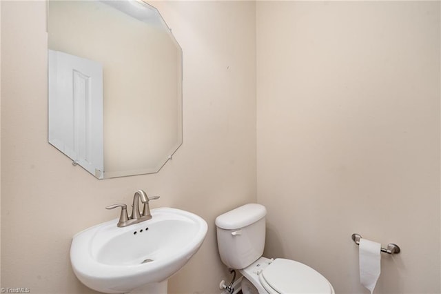 bathroom with toilet and sink