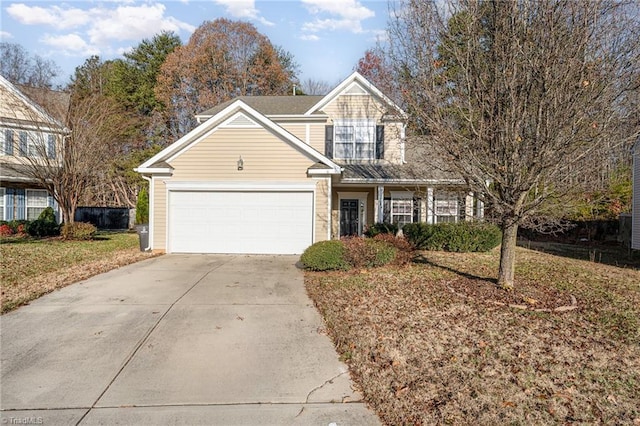 front of property featuring a front lawn and a garage