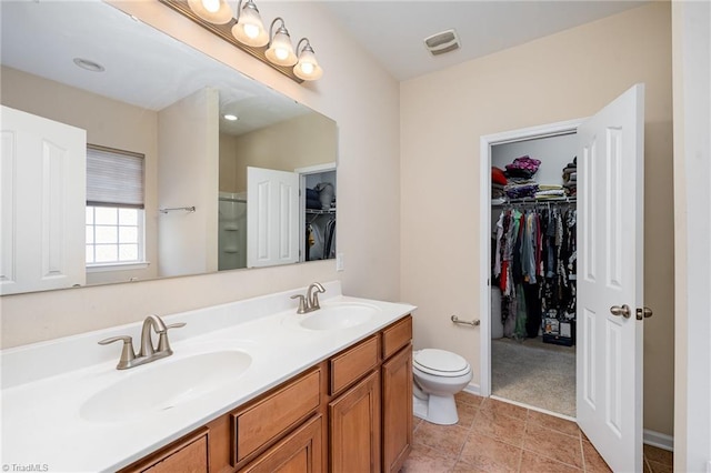 bathroom featuring tile patterned flooring, vanity, and toilet