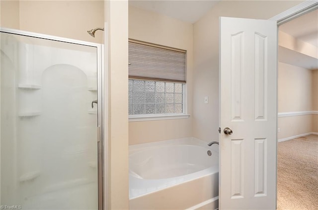 bathroom featuring shower with separate bathtub