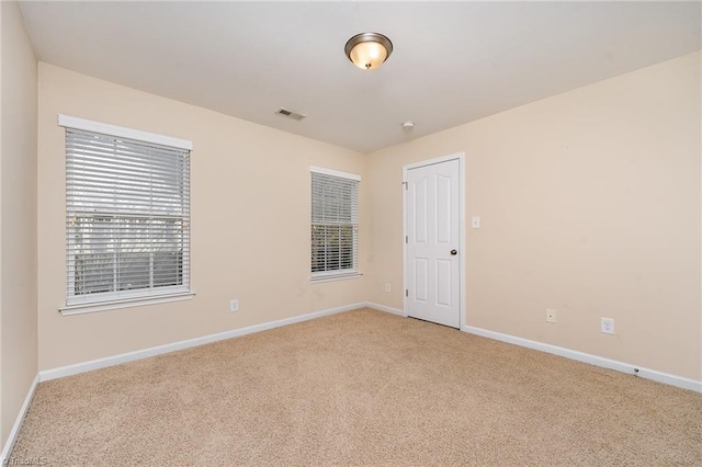 empty room featuring light carpet