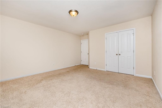 unfurnished bedroom featuring carpet floors and a closet